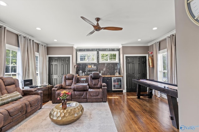 living room featuring beverage cooler, dark wood-type flooring, plenty of natural light, and ceiling fan