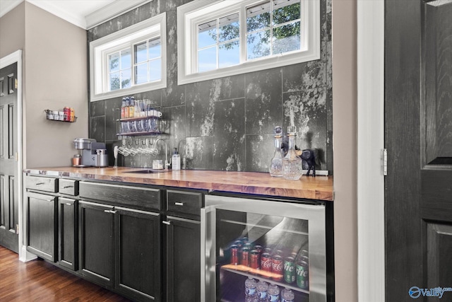 4716 Slalom Run SE, Owens Cross Roads, AL 35763 - bar featuring crown molding, a sink, wine cooler, a dry bar, and backsplash