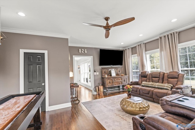 living room featuring ornamental molding, dark wood-type flooring, and ceiling fan