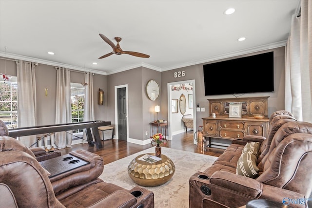 living room with a wealth of natural light, crown molding, ceiling fan, and dark hardwood / wood-style flooring