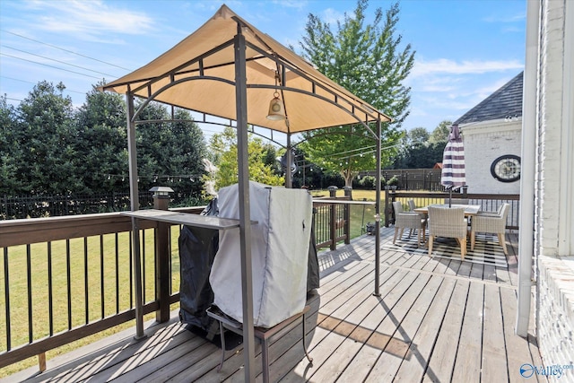 4716 Slalom Run SE, Owens Cross Roads, AL 35763 - wooden deck with a gazebo, fence, outdoor dining area, and a yard