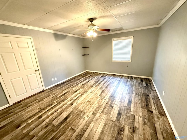 unfurnished room with hardwood / wood-style floors, crown molding, baseboards, and ceiling fan