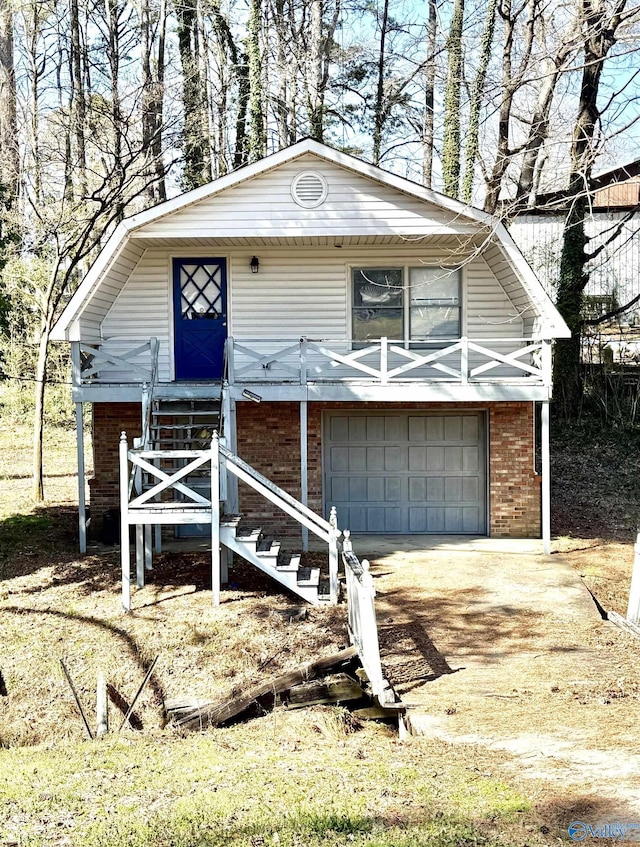 view of front of home with brick siding, driveway, and a garage