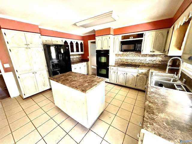 kitchen featuring light tile patterned floors, backsplash, black appliances, and a sink