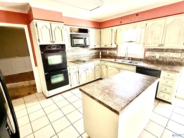 kitchen featuring a sink, tasteful backsplash, black appliances, and light tile patterned floors