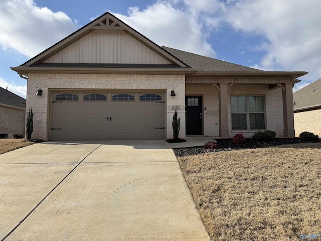 view of front of home with a garage, concrete driveway, brick siding, and roof with shingles