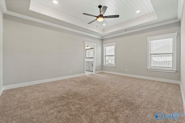 carpeted empty room with ornamental molding, a tray ceiling, recessed lighting, and baseboards