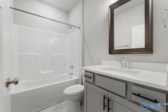 bathroom featuring toilet, marble finish floor, shower / tub combination, and vanity