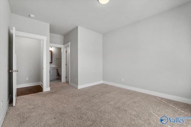 unfurnished bedroom with carpet and baseboards