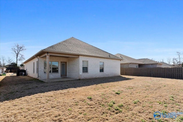 rear view of house featuring a yard, central AC, a patio area, and fence