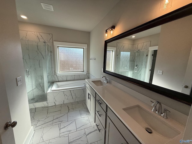 bathroom featuring marble finish floor, a marble finish shower, visible vents, and a sink