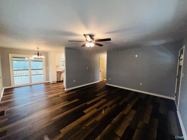 unfurnished living room featuring ceiling fan with notable chandelier and dark hardwood / wood-style flooring