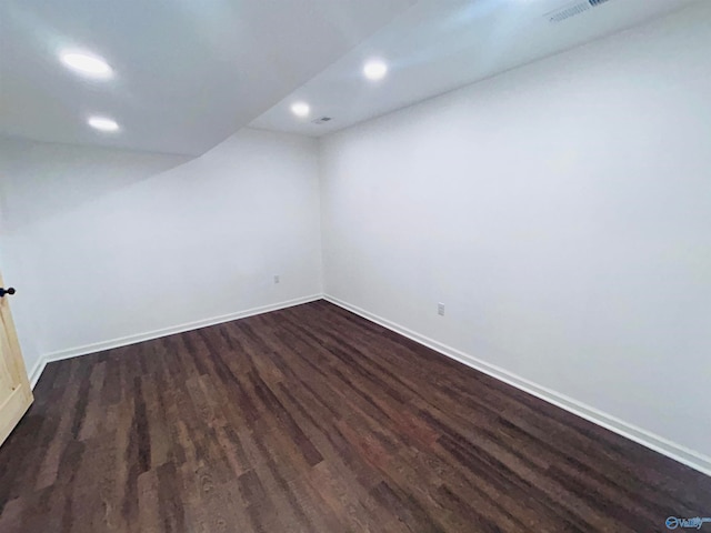 spare room with dark hardwood / wood-style floors