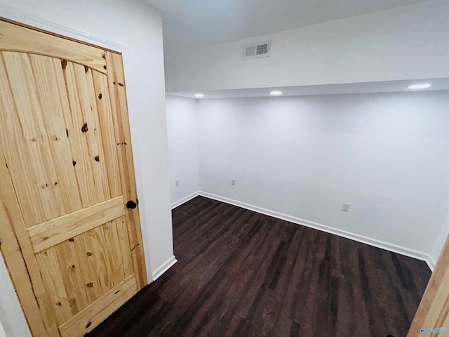 unfurnished room featuring dark wood-type flooring