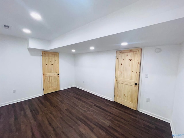 basement with dark hardwood / wood-style flooring