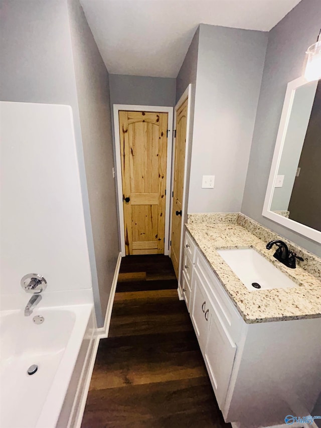 bathroom featuring shower / bath combination, vanity, and hardwood / wood-style floors