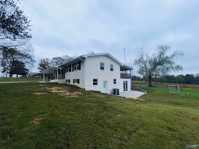 view of home's exterior with a lawn and central AC