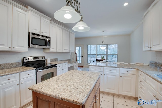 kitchen featuring kitchen peninsula, stainless steel appliances, pendant lighting, white cabinets, and a center island