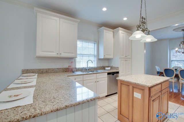 kitchen featuring pendant lighting, dishwasher, a center island, sink, and white cabinetry