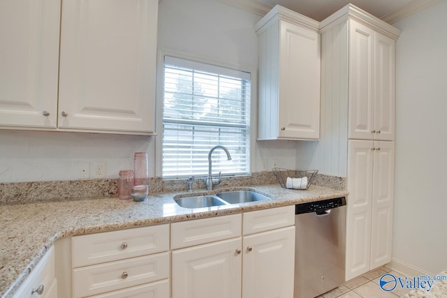 kitchen with white cabinetry, sink, light stone counters, stainless steel dishwasher, and light tile patterned flooring