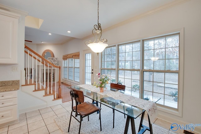 dining room with plenty of natural light, light tile patterned floors, and crown molding