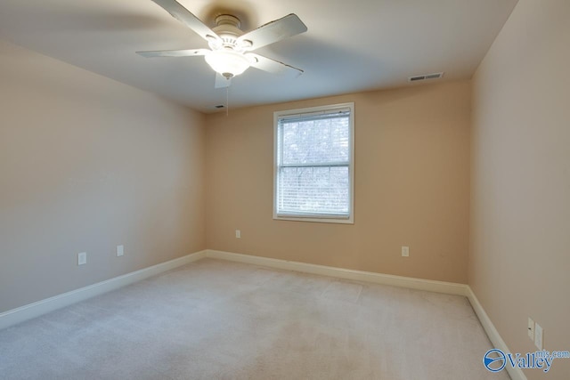 empty room featuring light carpet and ceiling fan