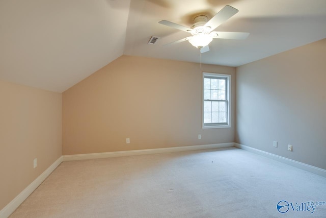 additional living space with light colored carpet, vaulted ceiling, and ceiling fan