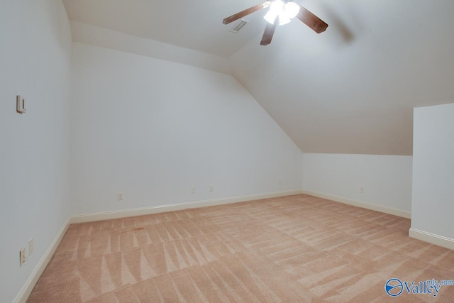 additional living space featuring light carpet, ceiling fan, and vaulted ceiling