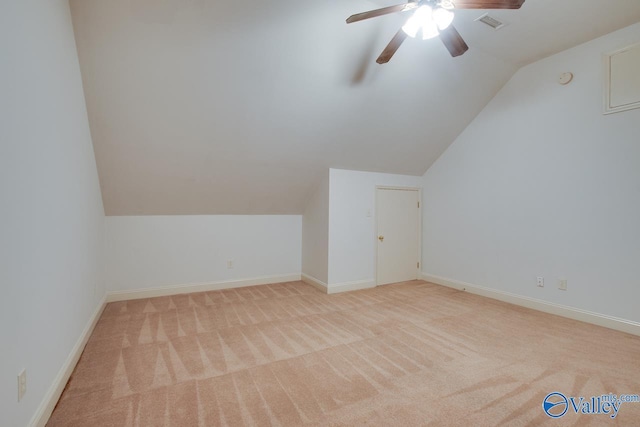 bonus room with ceiling fan, light colored carpet, and vaulted ceiling