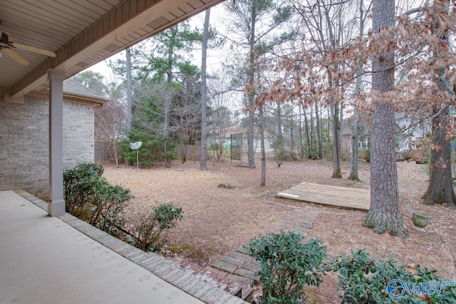 view of yard featuring ceiling fan and a patio area