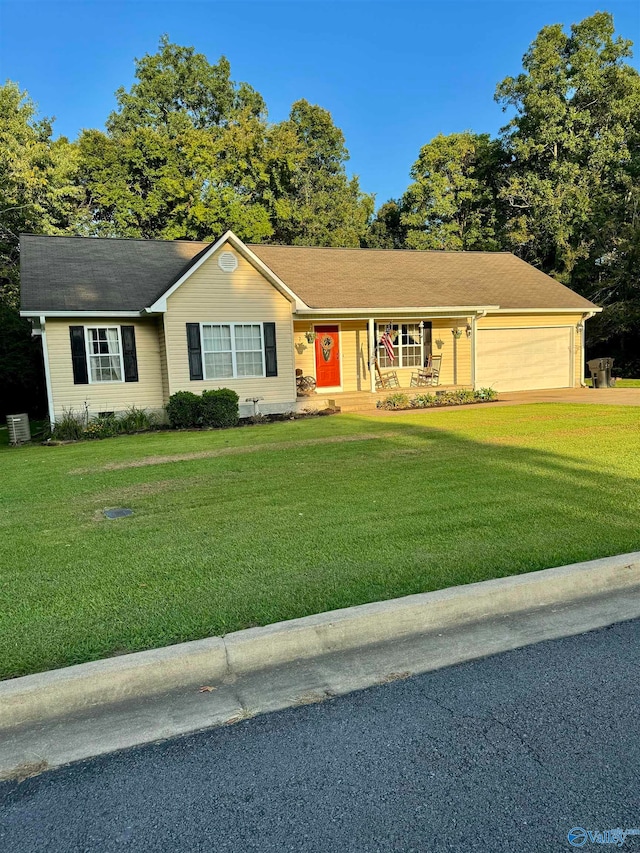 single story home featuring a front yard and a garage