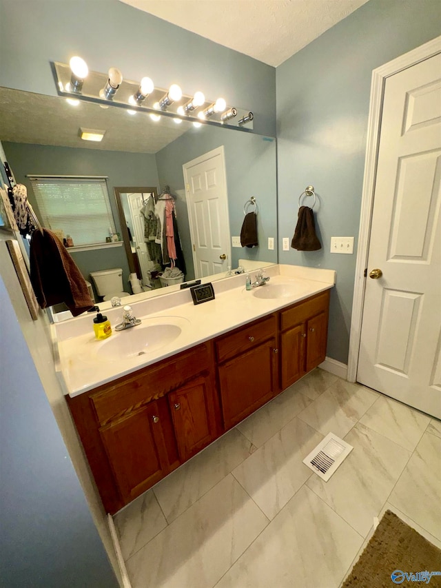 bathroom featuring tile patterned flooring and vanity