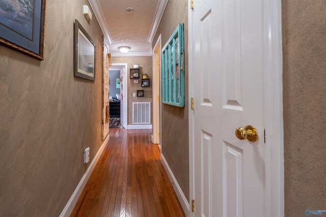 kitchen with hardwood / wood-style flooring, sink, ornamental molding, and white appliances