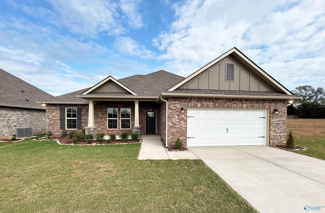 craftsman house featuring a garage, a front yard, and central air condition unit