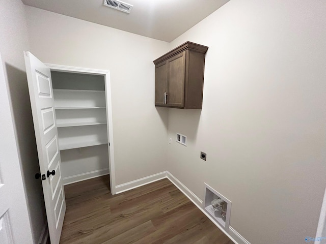 laundry room with cabinets, electric dryer hookup, washer hookup, and dark hardwood / wood-style flooring