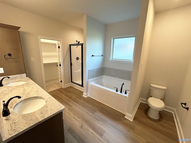 full bathroom featuring hardwood / wood-style flooring, vanity, independent shower and bath, and toilet