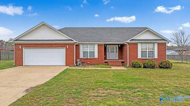 23311 Toone Rd, Elkmont, AL 35620 - ranch-style home featuring concrete driveway, fence, an attached garage, a front lawn, and brick siding