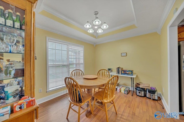 23311 Toone Rd, Elkmont, AL 35620 - dining area featuring crown molding, wood finished floors, a chandelier, and a raised ceiling