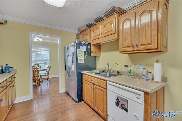 23311 Toone Rd, Elkmont, AL 35620 - kitchen featuring light countertops, light wood finished floors, stainless steel fridge, white dishwasher, and ornamental molding