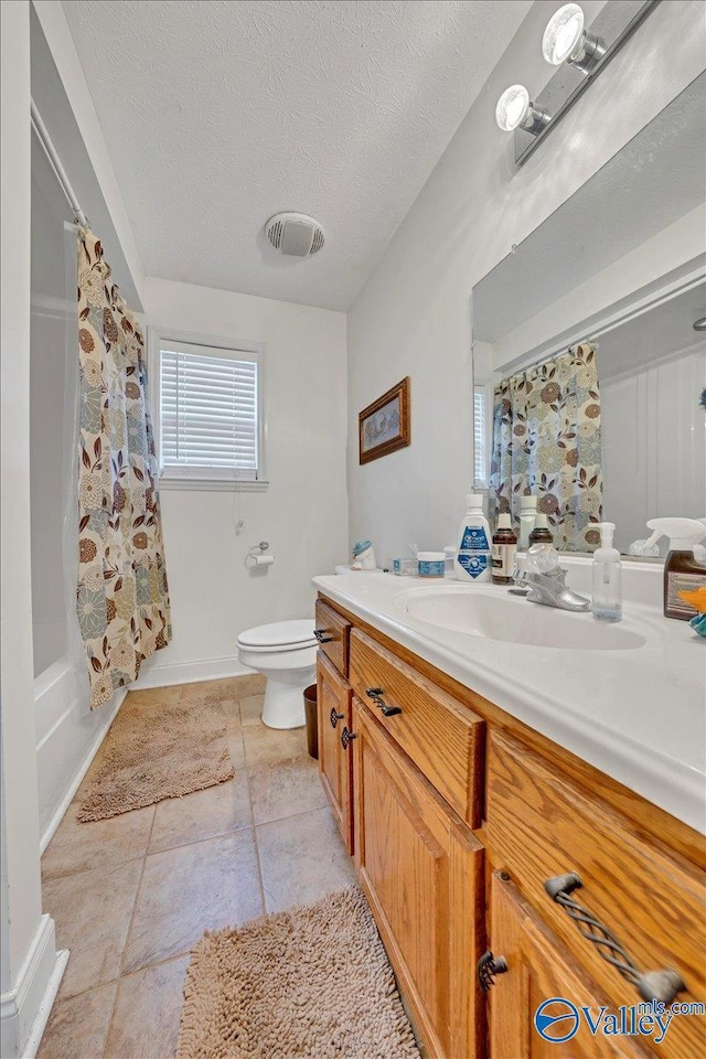 23311 Toone Rd, Elkmont, AL 35620 - full bathroom featuring vanity, toilet, a textured ceiling, visible vents, and shower / bath combination with curtain