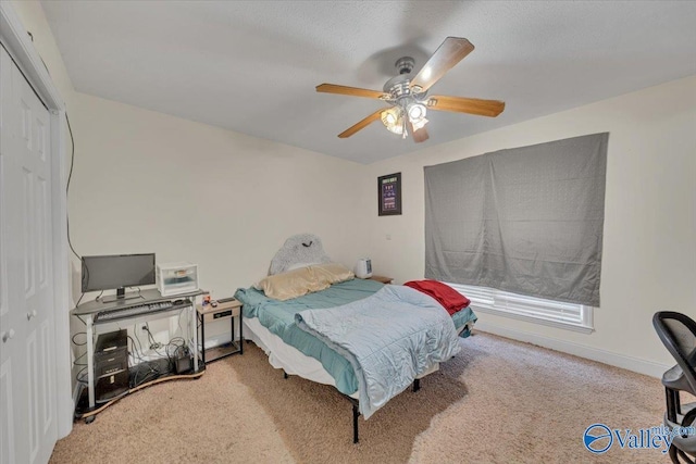 23311 Toone Rd, Elkmont, AL 35620 - carpeted bedroom featuring baseboards, a closet, and a ceiling fan