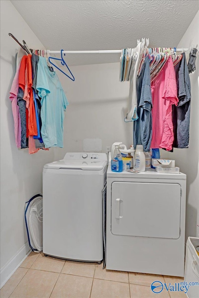 23311 Toone Rd, Elkmont, AL 35620 - laundry room featuring baseboards, a textured ceiling, tile patterned floors, washing machine and dryer, and laundry area