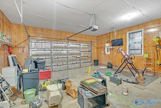 23311 Toone Rd, Elkmont, AL 35620 - garage with electric panel, wooden walls, and a garage door opener