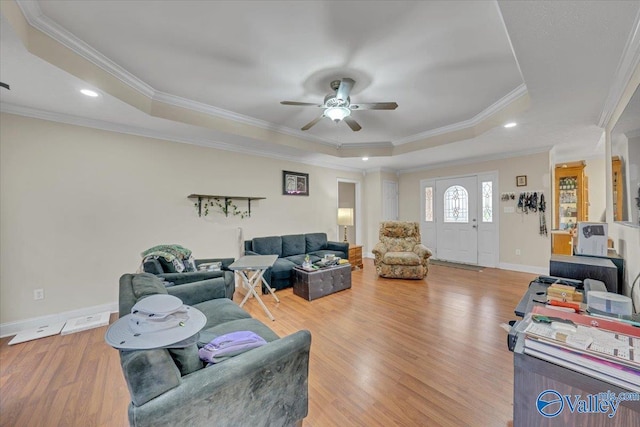 23311 Toone Rd, Elkmont, AL 35620 - living room featuring a tray ceiling, wood finished floors, ceiling fan, and ornamental molding