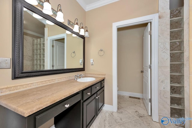 bathroom with crown molding, baseboards, and vanity