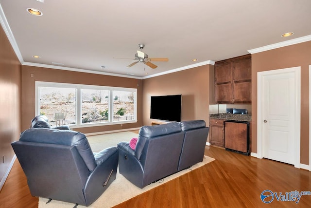 living room with baseboards, ceiling fan, and wood finished floors