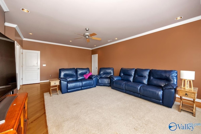 living room with crown molding, a ceiling fan, and recessed lighting