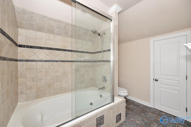 bathroom featuring tiled shower / bath, baseboards, and toilet