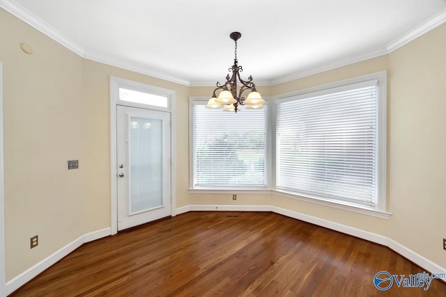 unfurnished dining area featuring crown molding, baseboards, an inviting chandelier, and dark wood finished floors