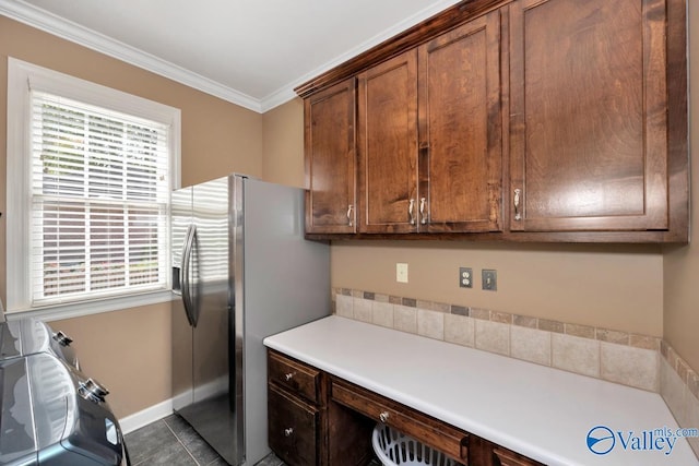laundry room with cabinet space, ornamental molding, a wealth of natural light, and baseboards